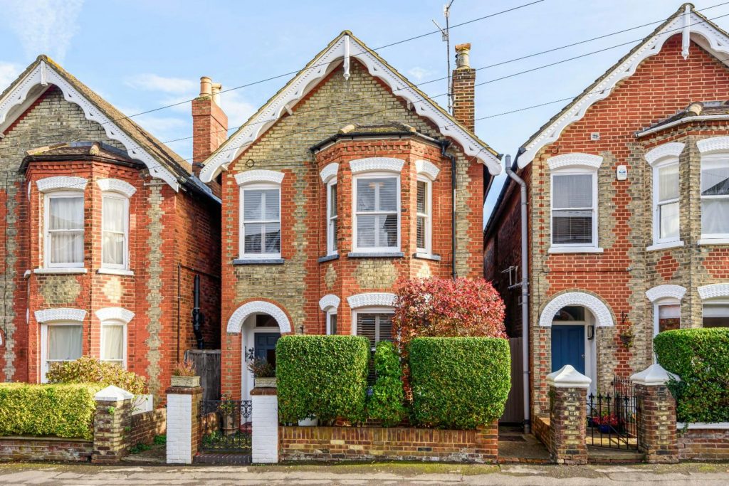 Estate agent in West Hendon Broadway analysing homes near Hampstead Heath